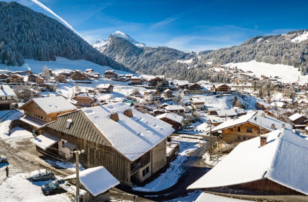 Chalet Ibex – Winter Exterior View Snowy aerial view of Morzine with Chalet Ibex in the foreground
