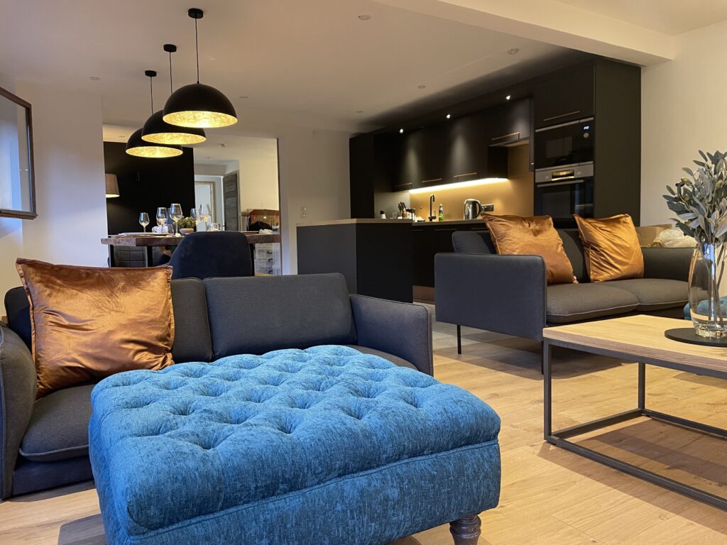 La Chaumine living area La Chaumine open plan living area with modern seating, large ottoman and contemporary kitchen