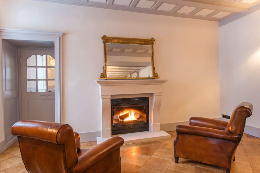 Le Manoir fireplace Fire place with leather arm chairs at the Manor Morzine