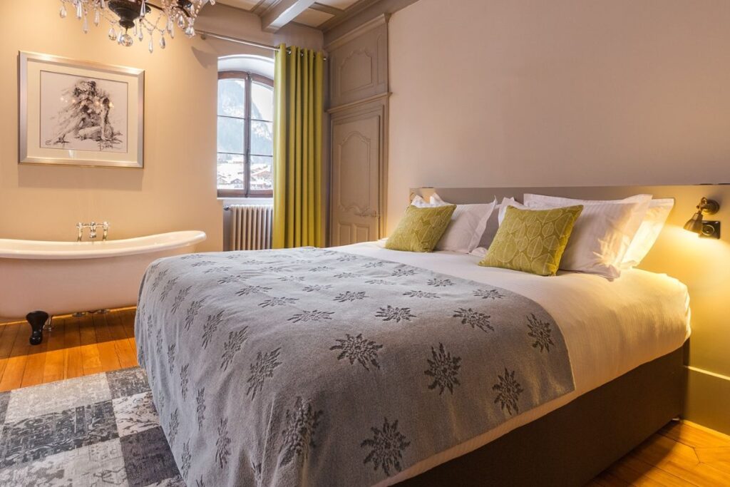 Le Manoir Morzine – Room 1 Le Manoir Morzine Room 1 – spacious double bedroom with roll-top bath and alpine décor