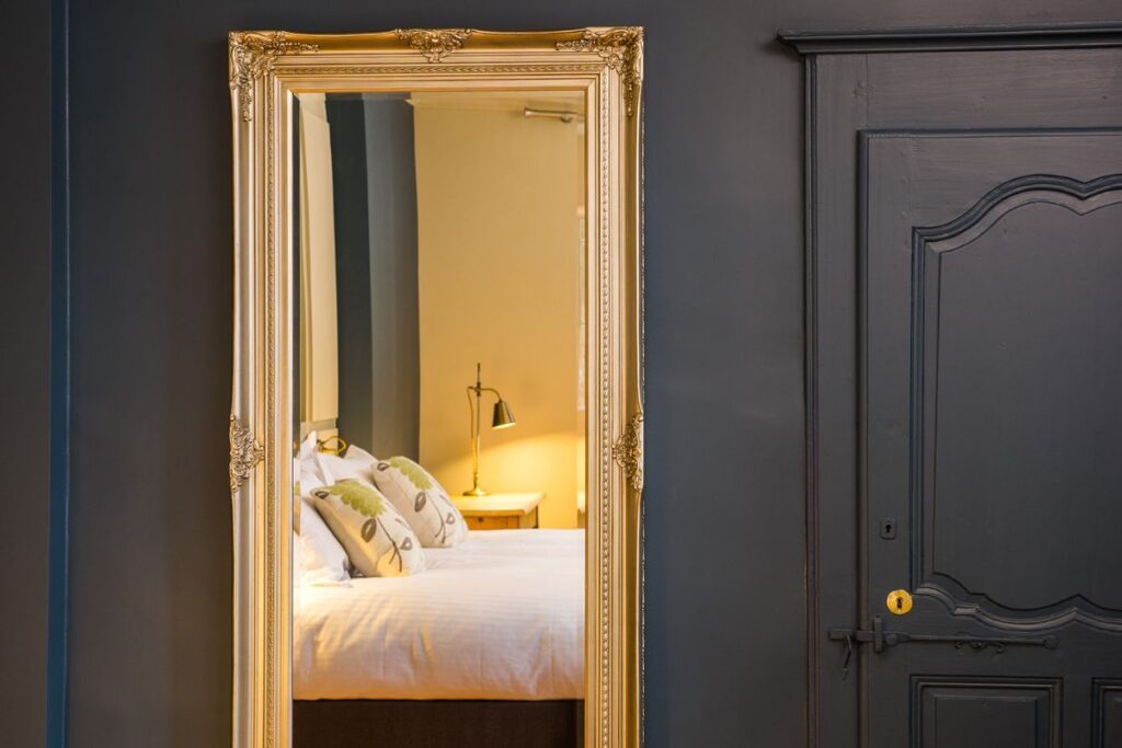 Le Manoir bedroom detail Bedroom detail with ornate Baroque mirror