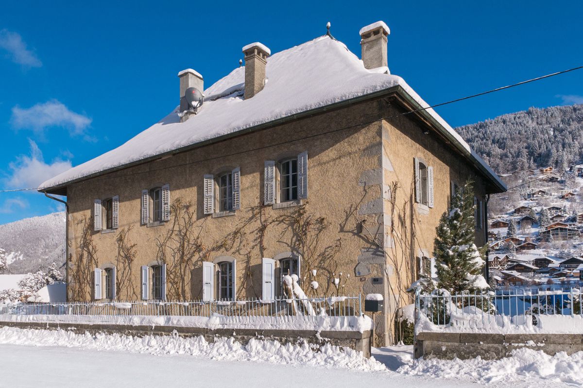 Le Manoir Morzine catered chalet exterior with snowy Alpine backdrop