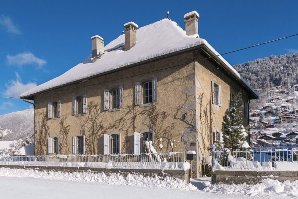 Le Manoir Morzine exterior Exterior of Le Manoir catered chalet in Morzine with snowy winter mountain views