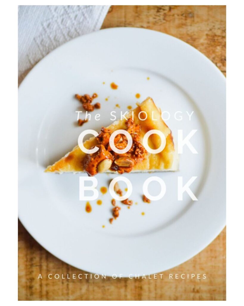 A slice of cake topped with nuts on a white plate, photographed for the Skiology Cook Book.
